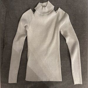 Soft turtleneck sweater with shoulder cut outs